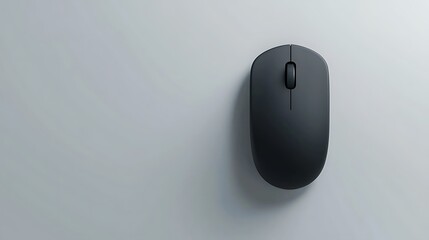 A black computer mouse is sitting on a white wall