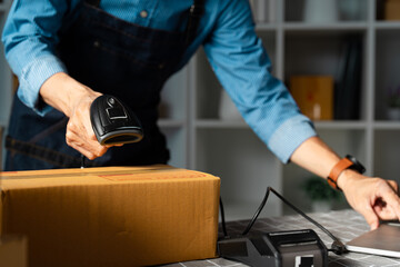 Startup entrepreneur scanning packages for online orders, illustrating efficient inventory...
