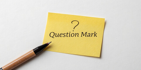 Another Curious Question Mark on a Bright Yellow Sticky Note Isolated for Emphasis