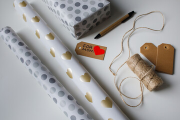 Tools for wrapping a present in gift paper for mom top view
