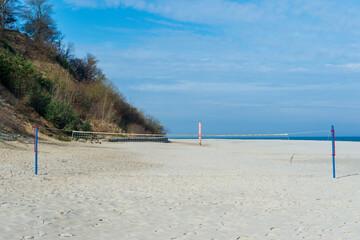 Empty Beach Volleyball Court on a Sandy Shore with Cliffs and Blue Sky in Jastrzębia Góra
