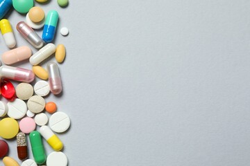 Various pills on gray background