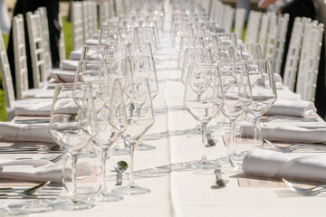 Served wedding table with plates, white chairs, napkins and wine glasses