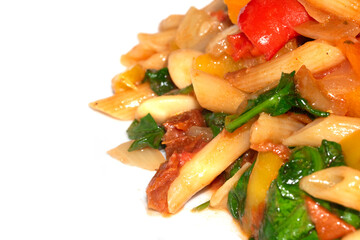 A Fresh Pasta Bake Meal With Spinach Tomatoes and Herbs on On A White Background Close Up