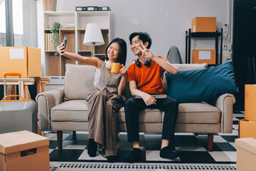 Smiling couple unpacking boxes in new house