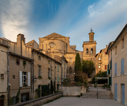 A view of Uz&egrave;s' charming streets at sunrise, as golden light bathes the historic stone facades, revealing the timeless beauty of this picturesque French town