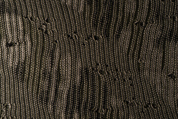 Close-up of textured, woven fabric with a mix of dark and light threads, creating an intricate pattern. Perfect for textile design