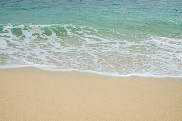Summer Seascape with Soft Ocean Waves Rolling onto the Shore in a Peaceful Coastal View.
