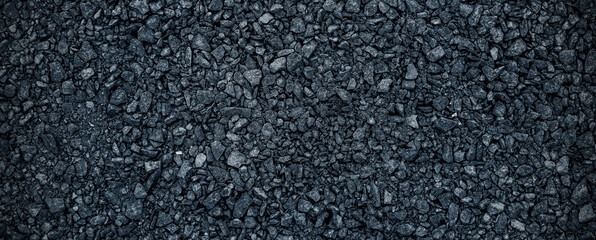 Black volcanic stone. Surface of basalt or granite close-up. Dark rough and textured rock.