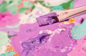 Artist palette with brush and colorful paint strokes.