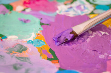  Artist mixing vibrant colors on his palette.World art day concept