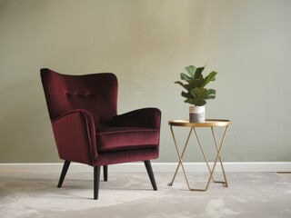 Luxurious Burgundy Velvet Armchair and Gold Side Table in a Modern Living Room