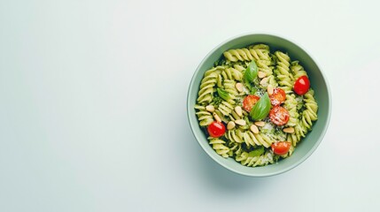 Green Pesto Pasta: A bowl of freshly made pesto pasta, featuring vibrant green spirals, cherry tomatoes, basil, and toasted pine nuts, captures the essence of Italian culinary delight.