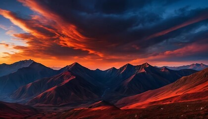 Dramatic sunset over a mountain range, with deep red and orange tones contrasting against dark blue shadows