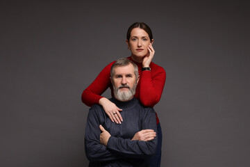 Obraz premium Family portrait of daughter and her father on dark background