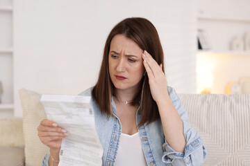 Worried woman reading pills side effects and instruction indoors