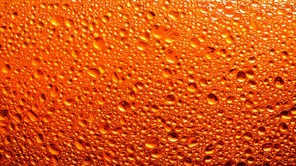 Close-up photography of a textured glass surface of a drink, with bubbles and foam, and condensed water