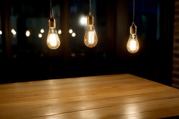 Warmly lit pendant lights hanging over a wooden table in a cozy café setting