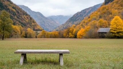 Fototapeta premium Empty wooden bench in autumnal valley landscape. Possible use Stock photo for nature, travel, or outdoor recreation