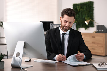 Fototapeta premium Man working with document at table in office