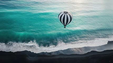 Hot air balloon over ocean waves, coastal view