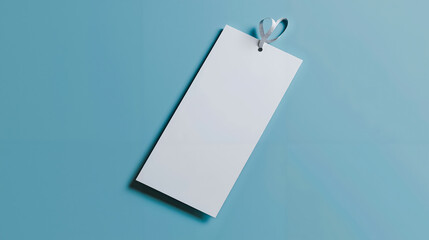 A blank white paper tag hanging on a blue background