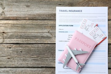 Medical tourism. Travel insurance application form, plane model, passport and flight tickets on...