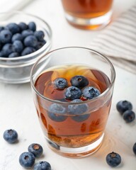 Tea with blueberry flavour in glass on isolated white background for your business food needs