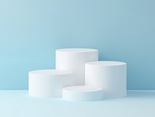 Four white cylindrical podiums set against a blue background.