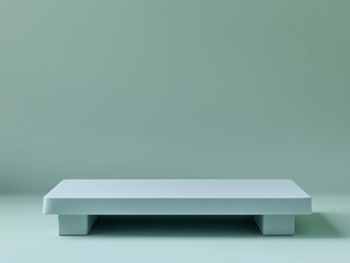 Elevated rectangular platform against a muted teal background.
