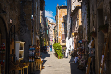 Old street of italian city offers shade and cold during hot summer days and offers for short walk to get lost in the medieval streets when travelling in Tuscany during hot summer day.