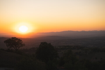 Romantic colorful sunset over the Tuscany landscape late on September when summer slowly ends is very charming and evokes calm and peaceful relaxation over the good glass of wine. Grosseto region