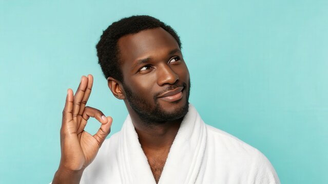 man in bathrobe showing ok sign.  He's looking thoughtfully, conveying a sense of contentment and relaxation.