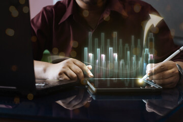 Businessman analyzing financial growth on a digital tablet with a glowing stock market chart overlay. Concept of investment, trading, and business strategy in a digital economy.