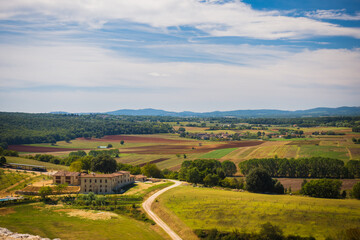 Scenic view to the tuscany countryside during early September with hills on the background and fields and farms, Tuscany, Italy evokes romantic summer vacation and retreat from hustle of common days.