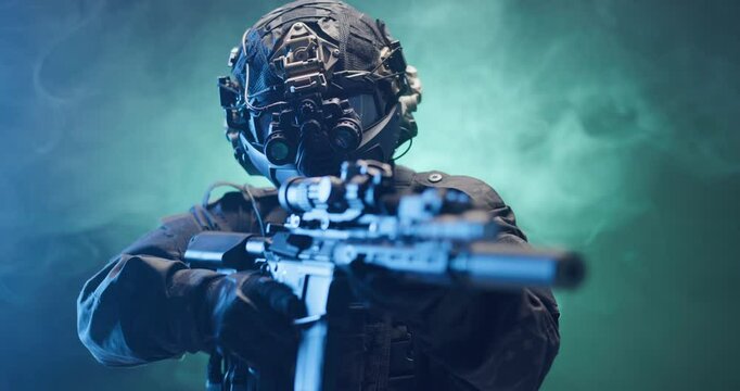 Soldier fully equipped with tactical gear and protection aiming his rifle at enemy with blue and green smoke in the background.