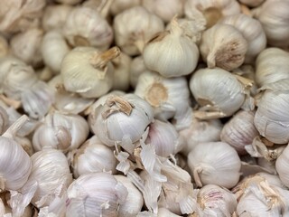 A lot of garlic in the box on sale in vegetable stand display at supermarket shop organic food, vegetarian food, healthy food