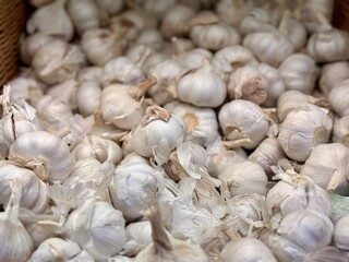 A lot of garlic in the box on sale in vegetable stand display at supermarket shop organic food, vegetarian food, healthy food