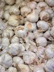 A lot of garlic in the box on sale in vegetable stand display at supermarket shop organic food, vegetarian food, healthy food