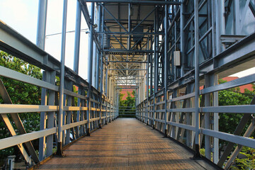 Low angle of an empty pedestrian bridge during the day.