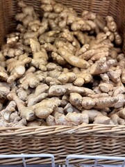 A lot of ginger roots in the box on sale in vegetable stand display at supermarket shop organic food, vegetarian food, healthy food