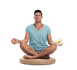 Man meditating with beautiful lotus flower in his hand on white background. Padmasana (yoga lotus...