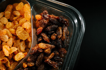 Colorful assortment of raisins in a clear container showcasing different varieties and textures