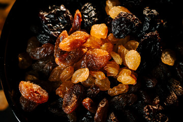 Brightly colored raisins displayed in a dark bowl highlighting their texture and variety in a close-up shot
