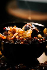 Enjoying a delicious bowl of mixed raisins and dried fruits during a cozy evening at home with family