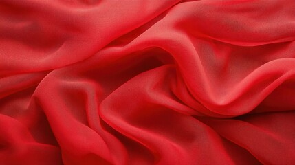 Obraz premium Flowing red tulle fabric captured in soft, elegant folds, forming a luxurious and abstract background with rich texture