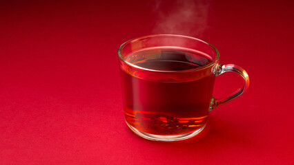 Steaming Glass Cup of Freshly Brewed Tea