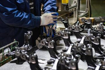 Fototapeta premium Factory automation production line. Automotive parts production line. Workers are producing car brake discs and various components in the machining workshop. Inside the automotive intelligent factory