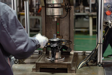 Factory automation production line. Automotive parts production line. Workers are producing car brake discs and various components in the machining workshop. Inside the automotive intelligent factory