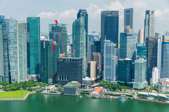 Singapore- July 19, 2024: Building view of modern skyscrapers along Marina Bay in the Raffles Place financial district from the Marina Bay Sands Skypark, Singapore.